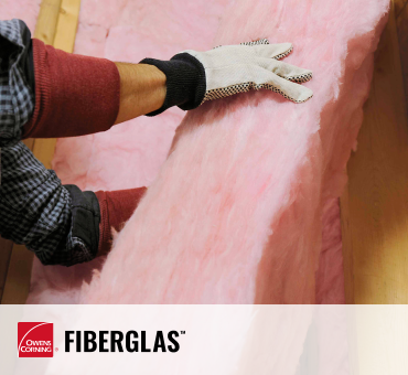 worker installing fiberglass insulation