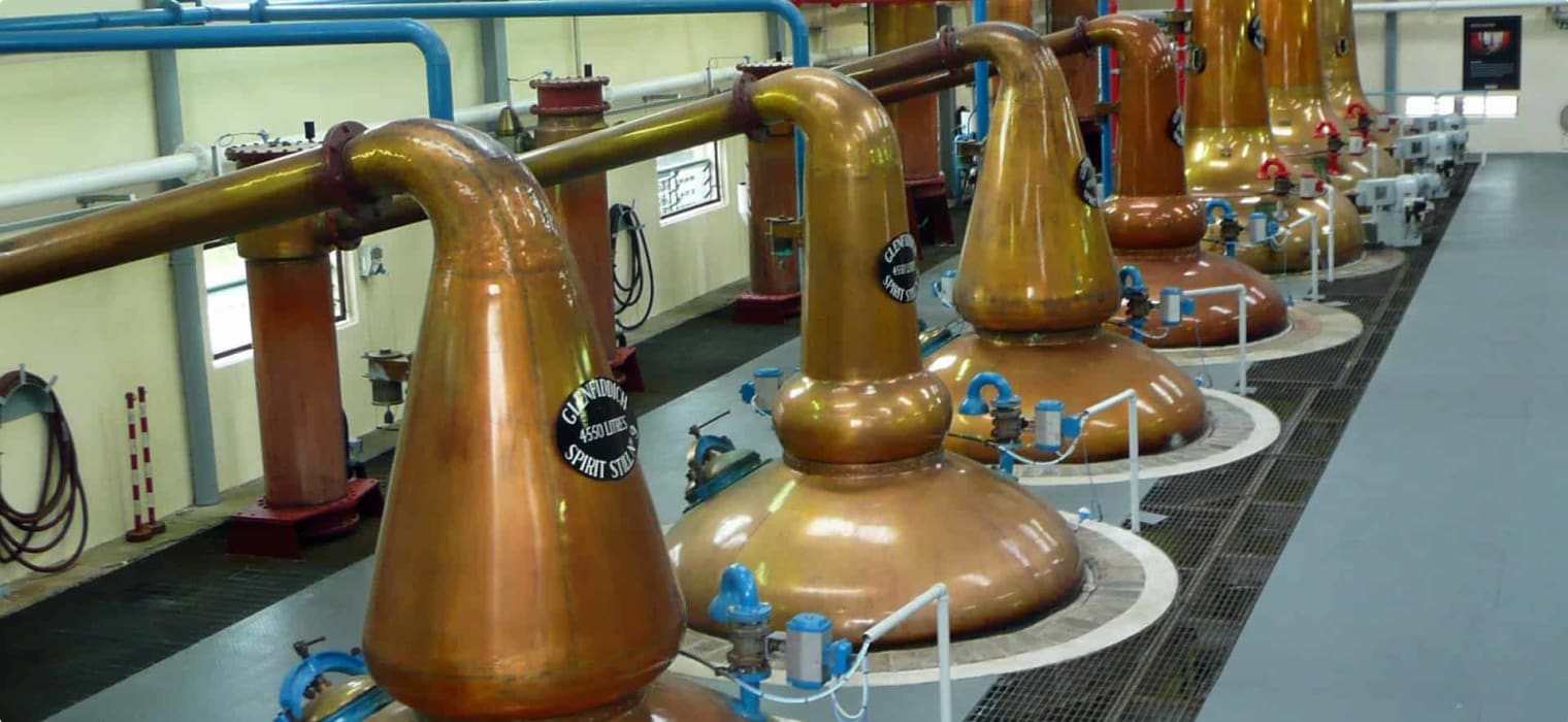 Modern pot stills in a distillery in Scotland