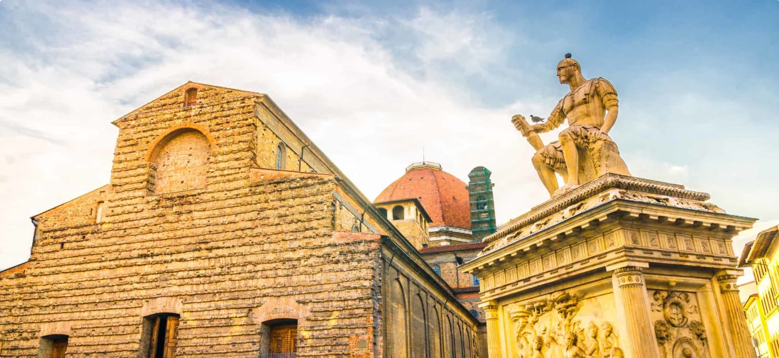 Basilica di San Lorenzo Cappelle Medicee chapel and Giovanni delle Bande Nere monument on Piazza di San Lorenzo square in historical centre of Florence city, blue sky white clouds, Tuscany, Italy