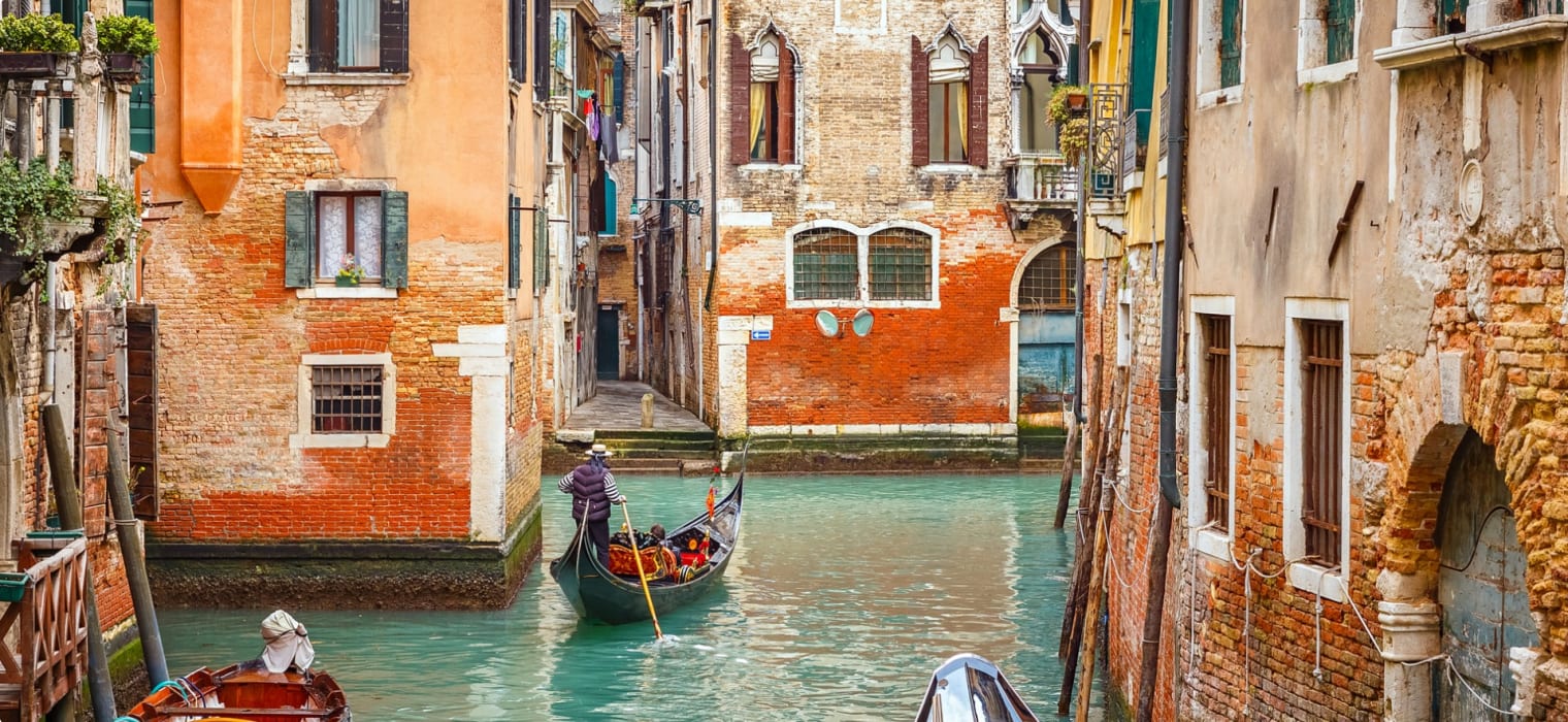 Gondolas on narrow canal in Venice, Italy