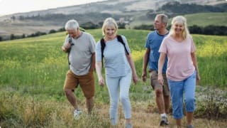 Mature aged travellers walking on grass