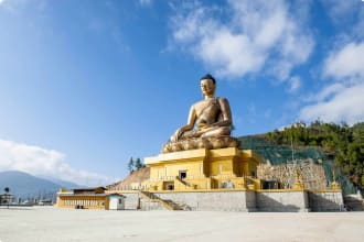 A giant Buddha statue under blue sky in Thimphu, Bhutan