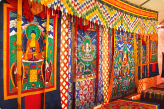 Photo of richly decorated Bhutanese Tapestry depicting religious symbols.