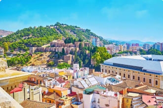 Malaga with view of the hill occupied with medieval Alcazaba fortress and topped with Gibralfaro Castle, Spain