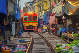 Rom Hoop market. Thai Railway with a local train run through Mae Klong Market in Samut Songkhram Province,