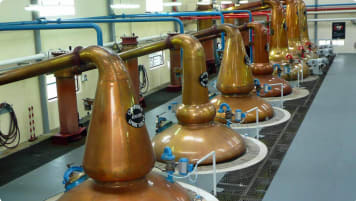 Modern pot stills in a distillery in Scotland