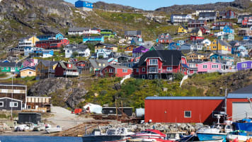 Colored houses on rocky hills in the coastline of Qaqortoq, Greenland.