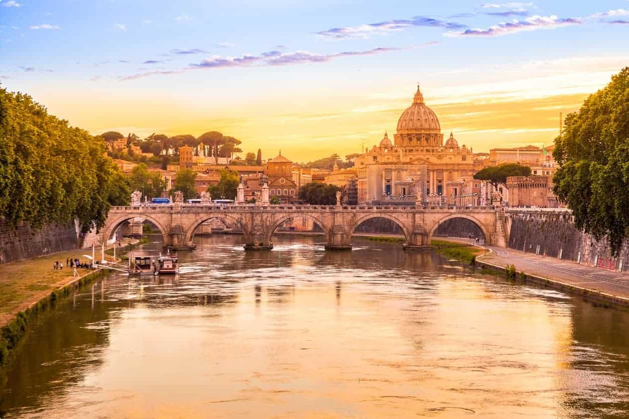 Rome at Sunset with San Pietro basilica, Sant'Angelo bridge and Tevere river in Roma, Italy