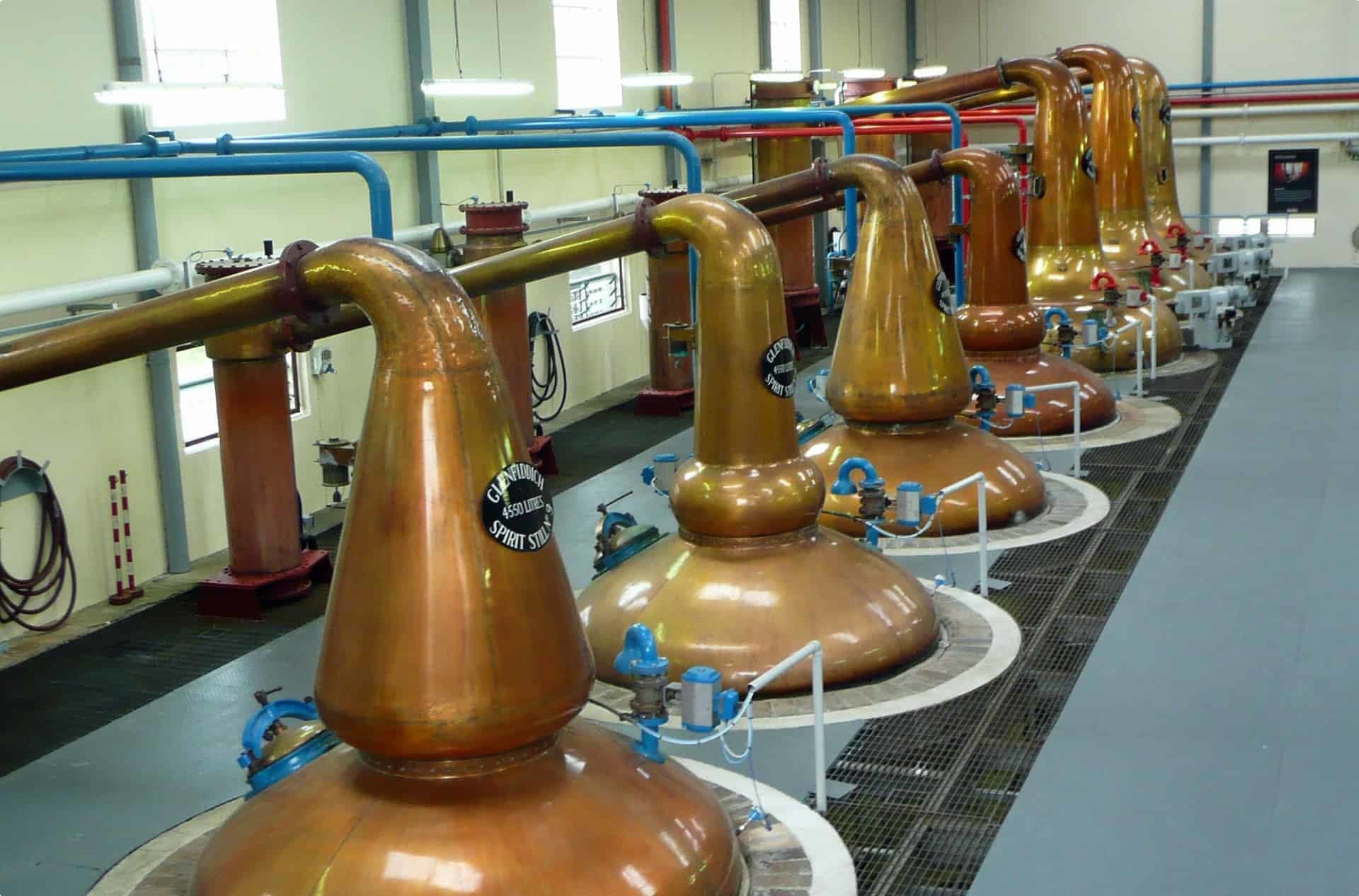 Modern pot stills in a distillery in Scotland