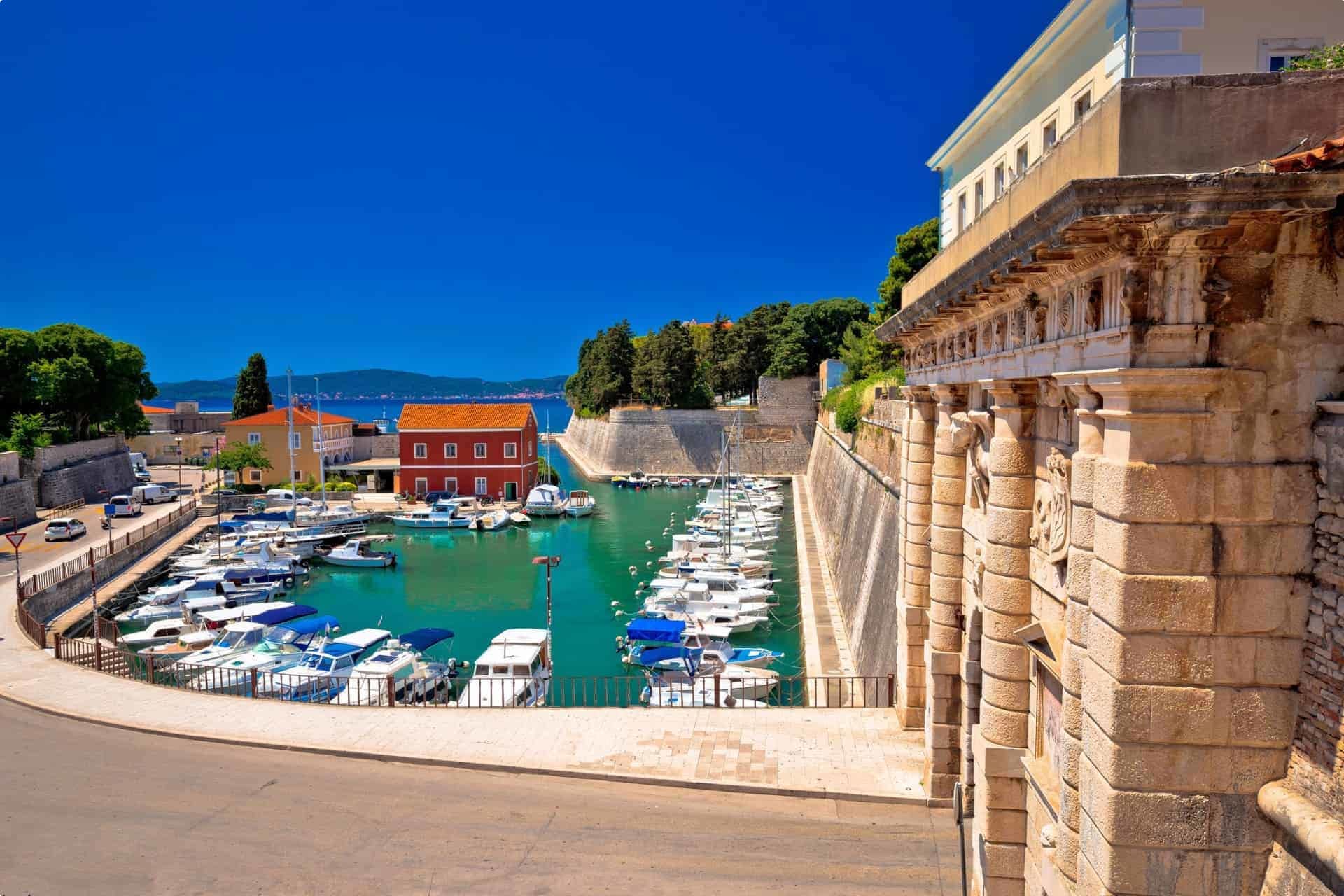 City gate to the walled city of Zadar in Croatia and a view of the harbour