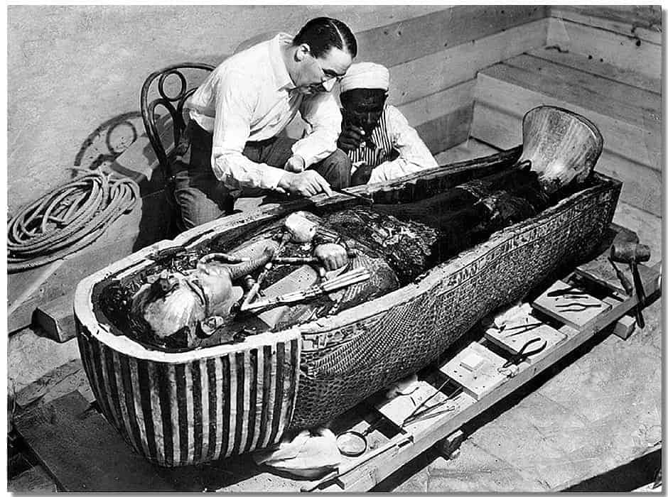 Howard Carter examines King Tutankhamen's mummy