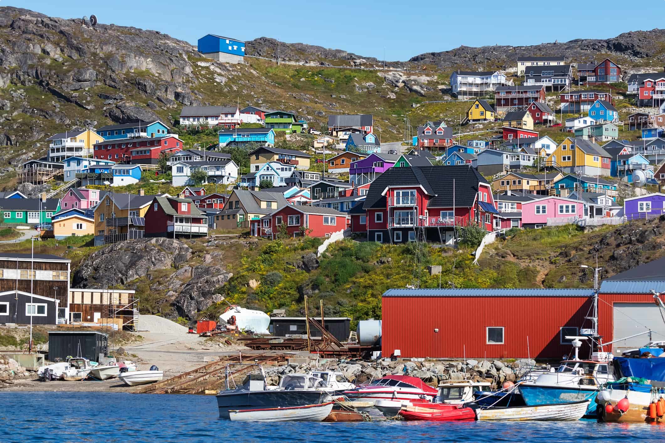 Colored houses on rocky hills in the coastline of Qaqortoq, Greenland.