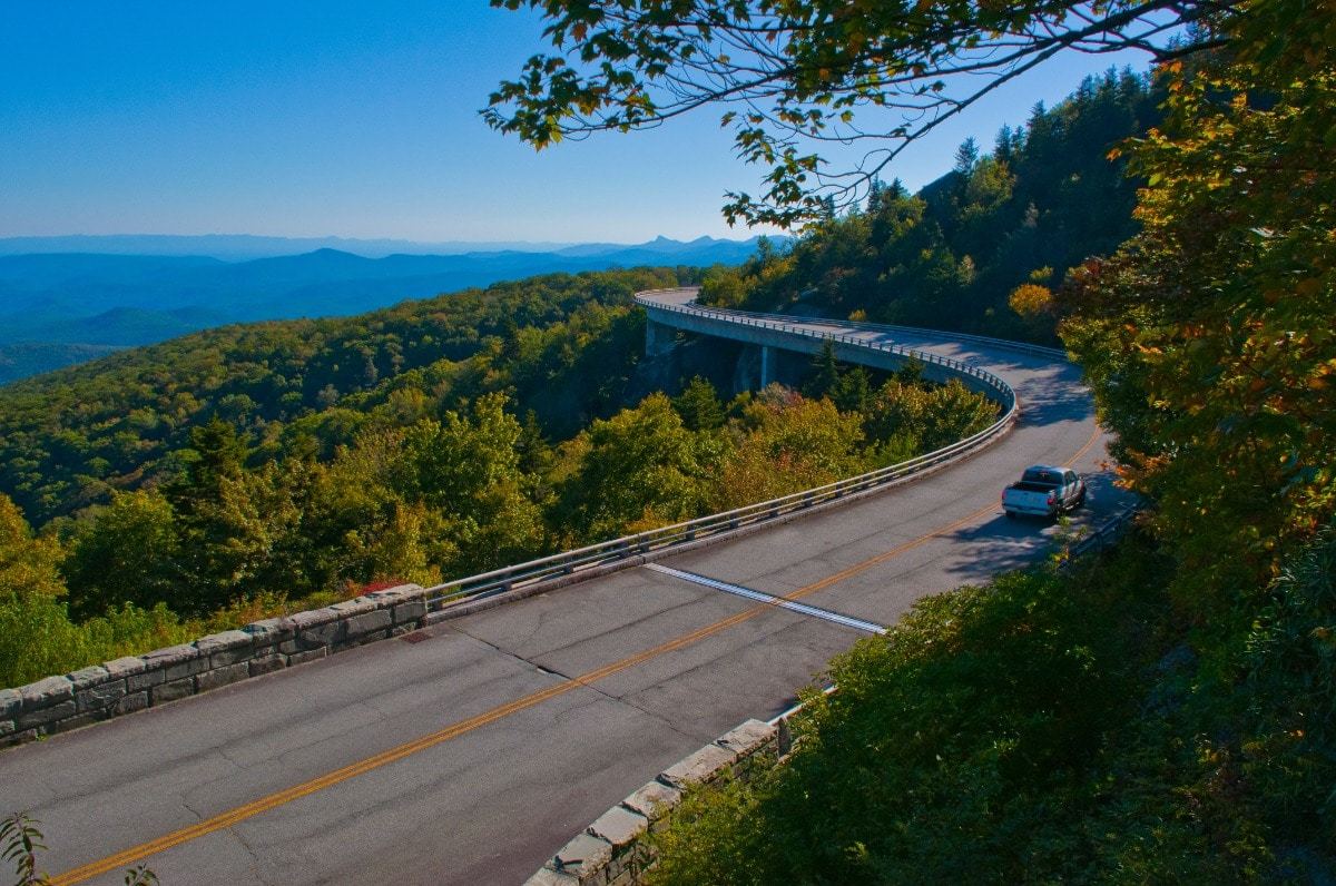 Blue Ridge Parkway with car driving on road, blue skies