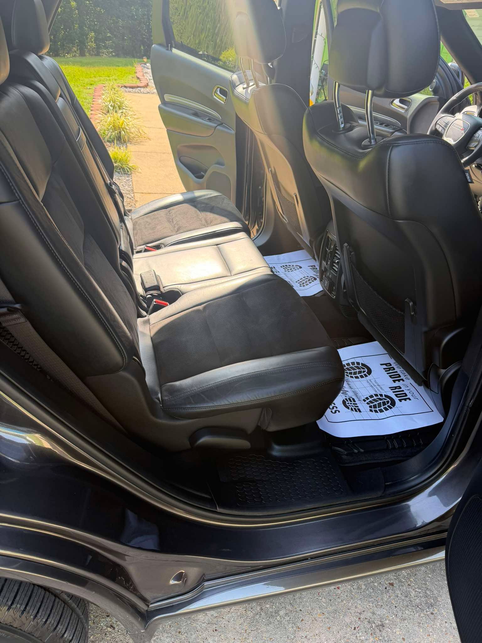 Clean Black Leather Rear Seats with Branded Mats
