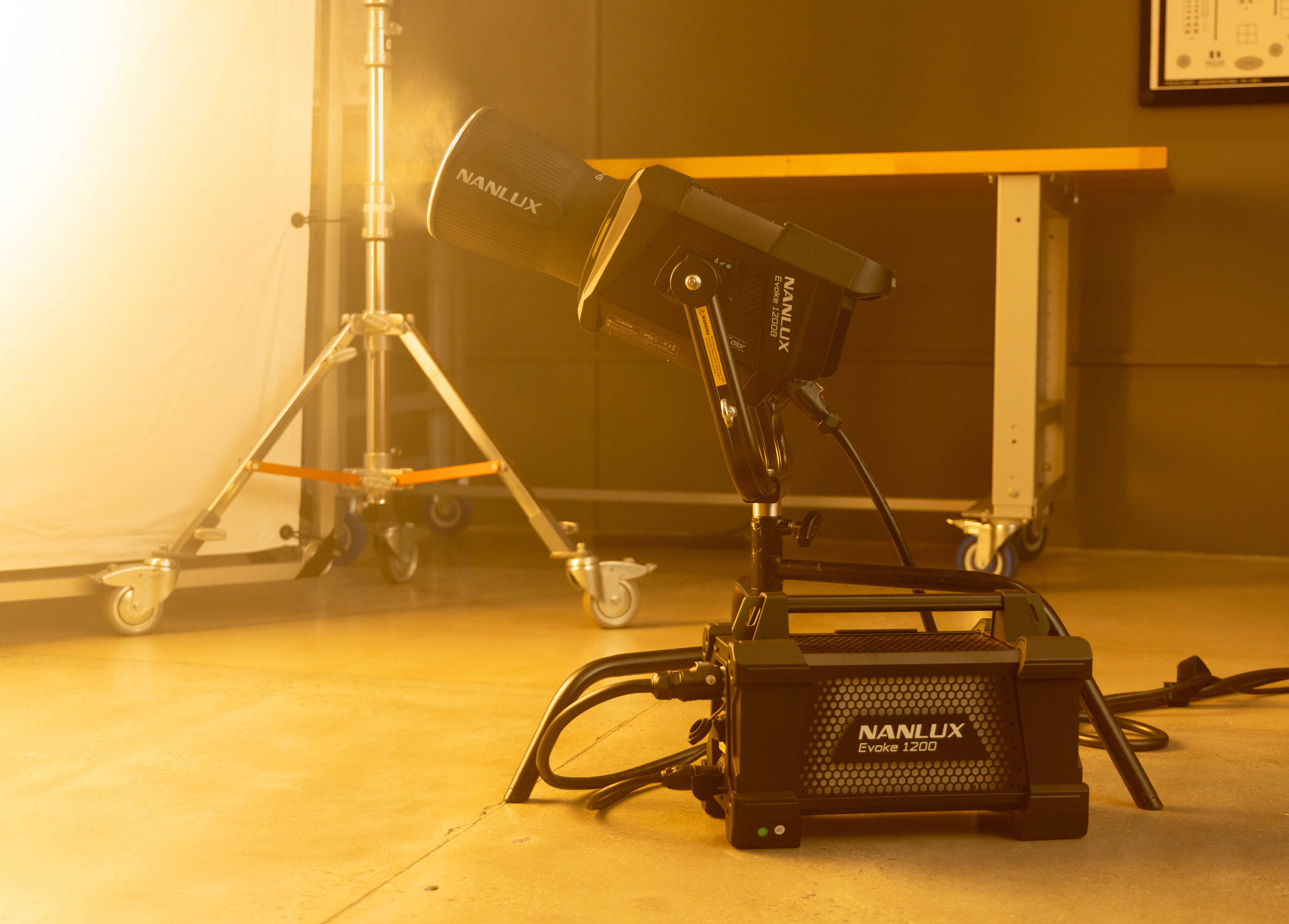The Evoke 1200B mounted to a turtle base, with its power supply on the ground next to it.