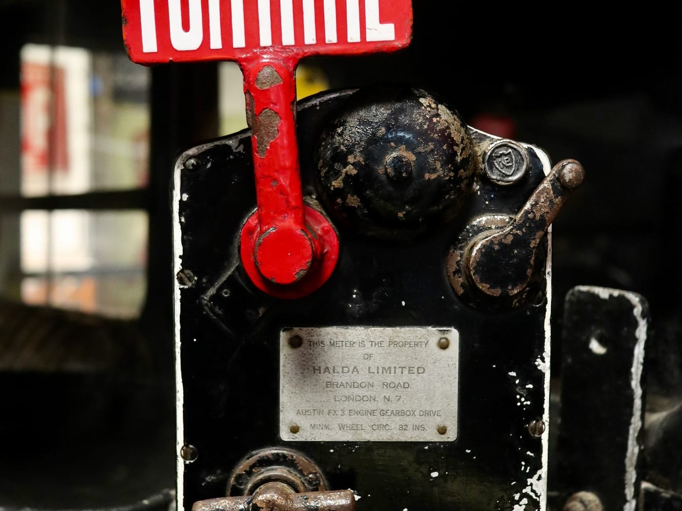 An image of a red and white meter machine on an old London Taxi found in a motor museum by @noblematt on unsplash.