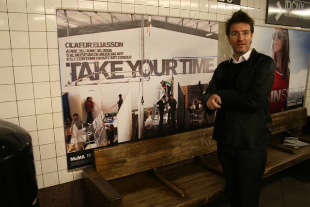 Olafur Eliasson with a poster of Take your time: Olafur Eliasson, 2008, Museum of Modern Art and P.S.1 Con