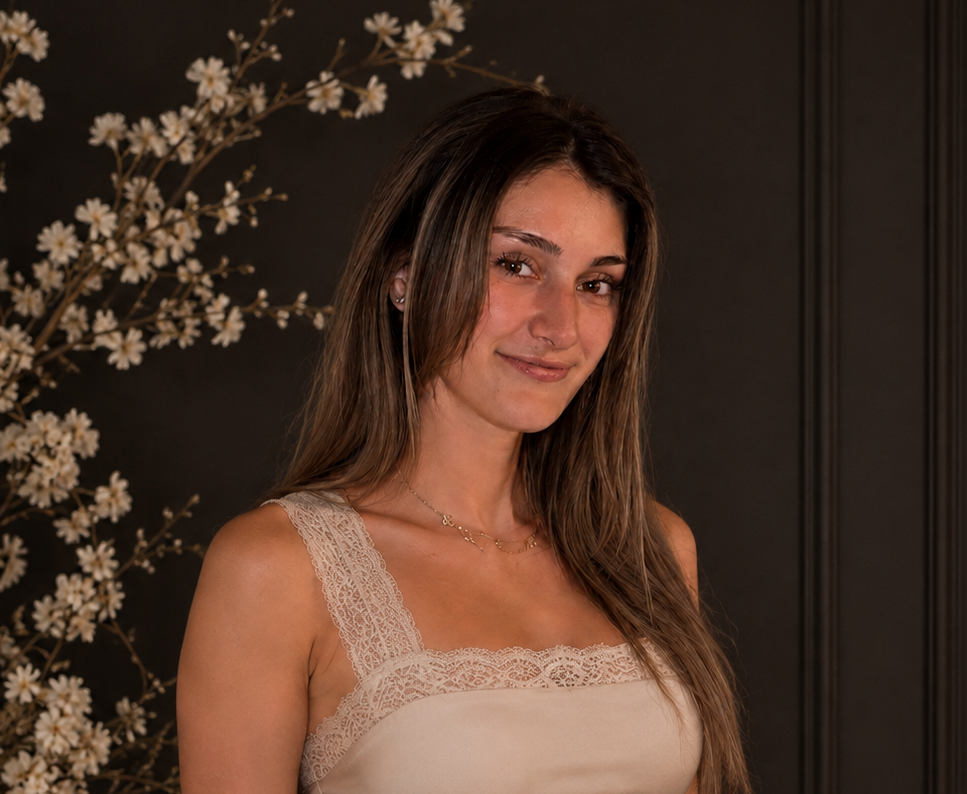 Portrait of Kait Allegrezza, founder of ALLEGRE, a woman-owned luxury coconut-soy candle brand based in San Diego, California, photographed beside delicate white flowering branches.