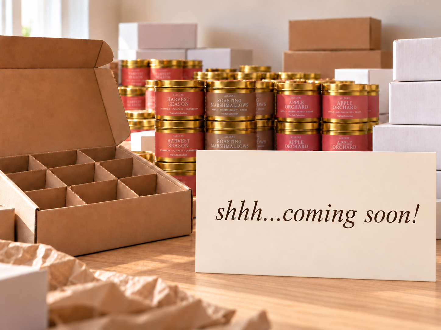 ALLEGRE luxury coconut-soy candles in gold tins arranged for wholesale and bulk orders, featuring Harvest Season, Roasting Marshmallows, and Apple Orchard alongside gift boxes and protective candle packaging for custom gifting and events.