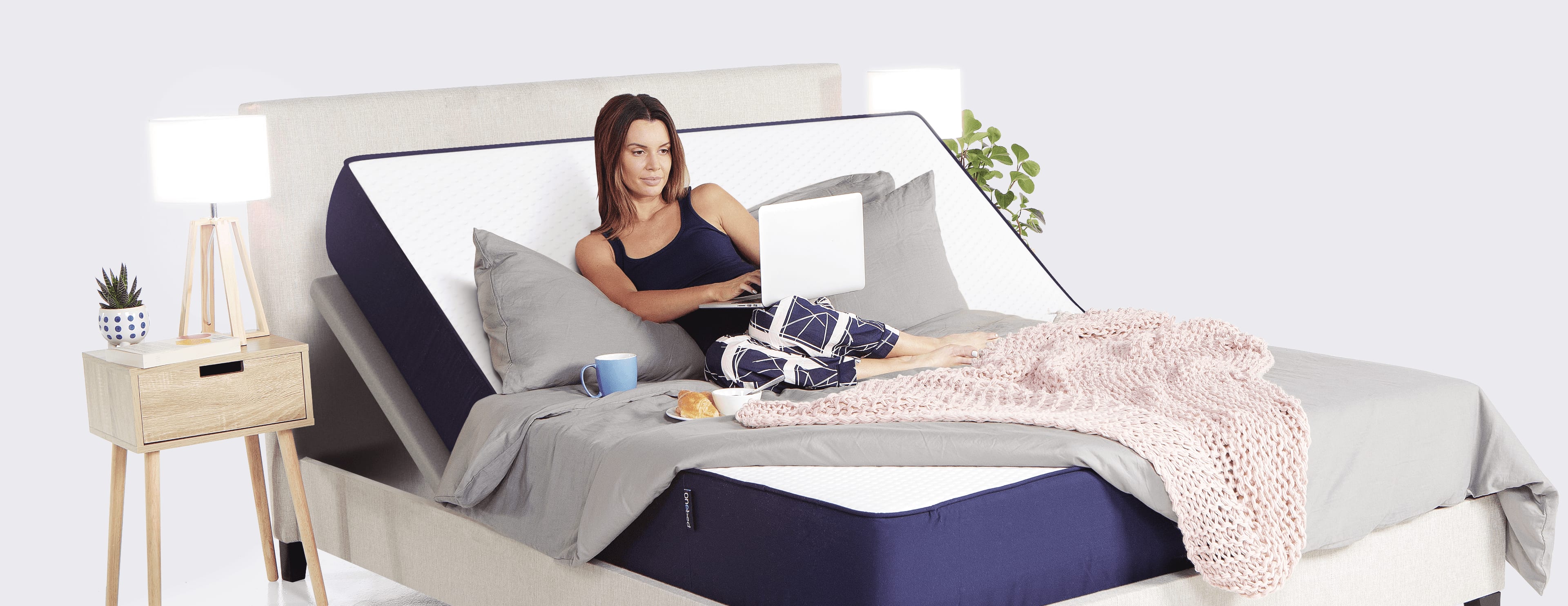Woman on Onebed Original Mattress on top of Onebed Adjustable Frame in Anti-Snore position
