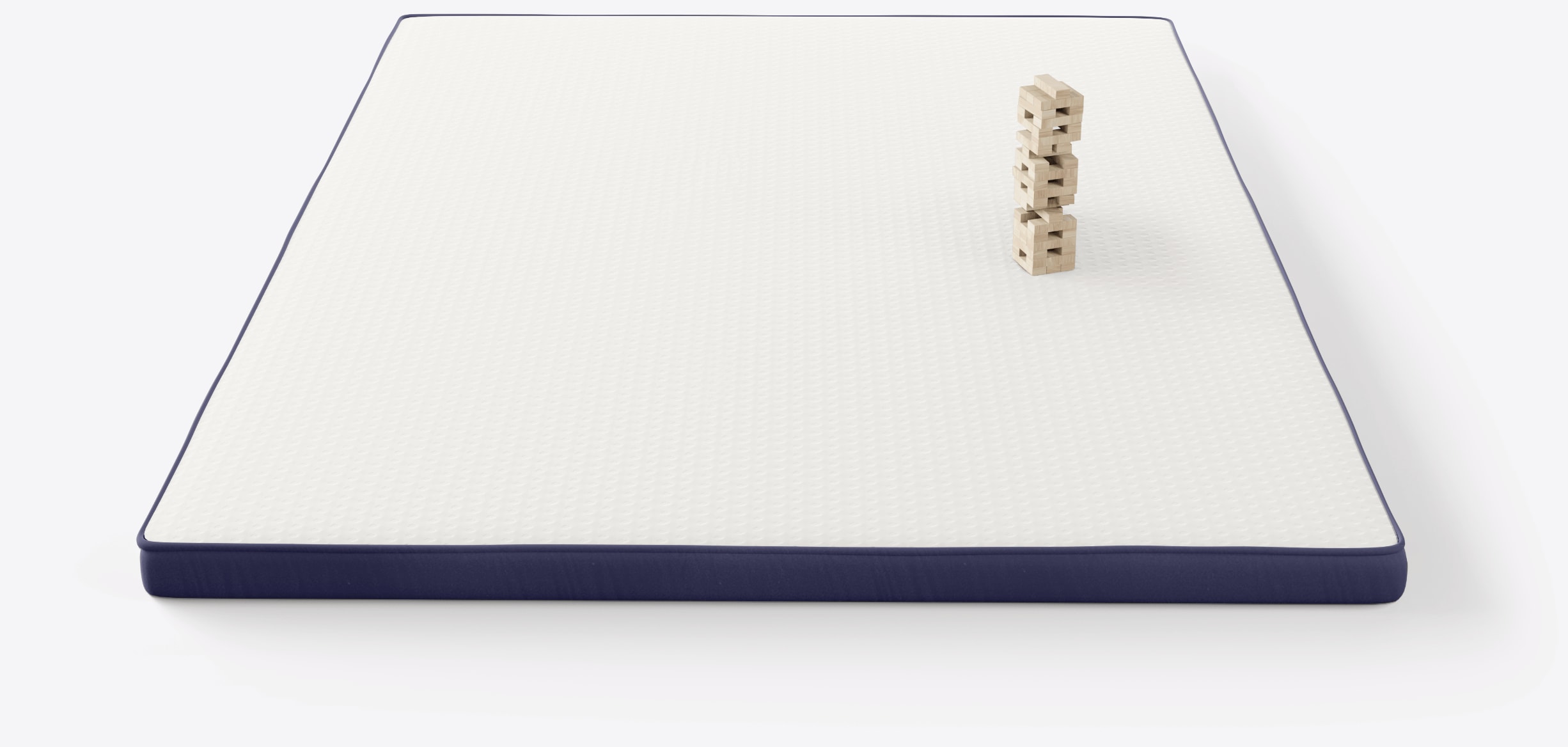 Onebed Topper looked from above with jenga tower on one side and footsteps next to it to portray do not disturb effect