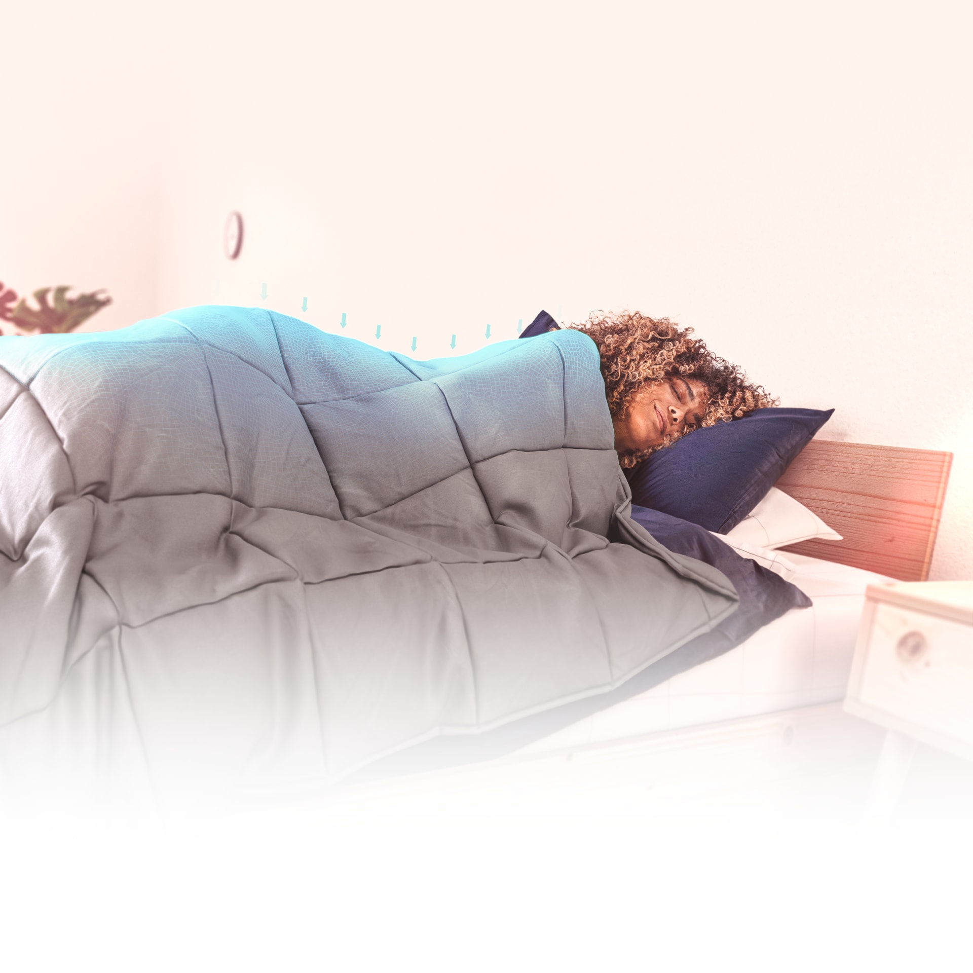 Person sleeping with the Onebed Weighted Blanket. Arrows fading in and out signifying the weight the blanket puts on the person.