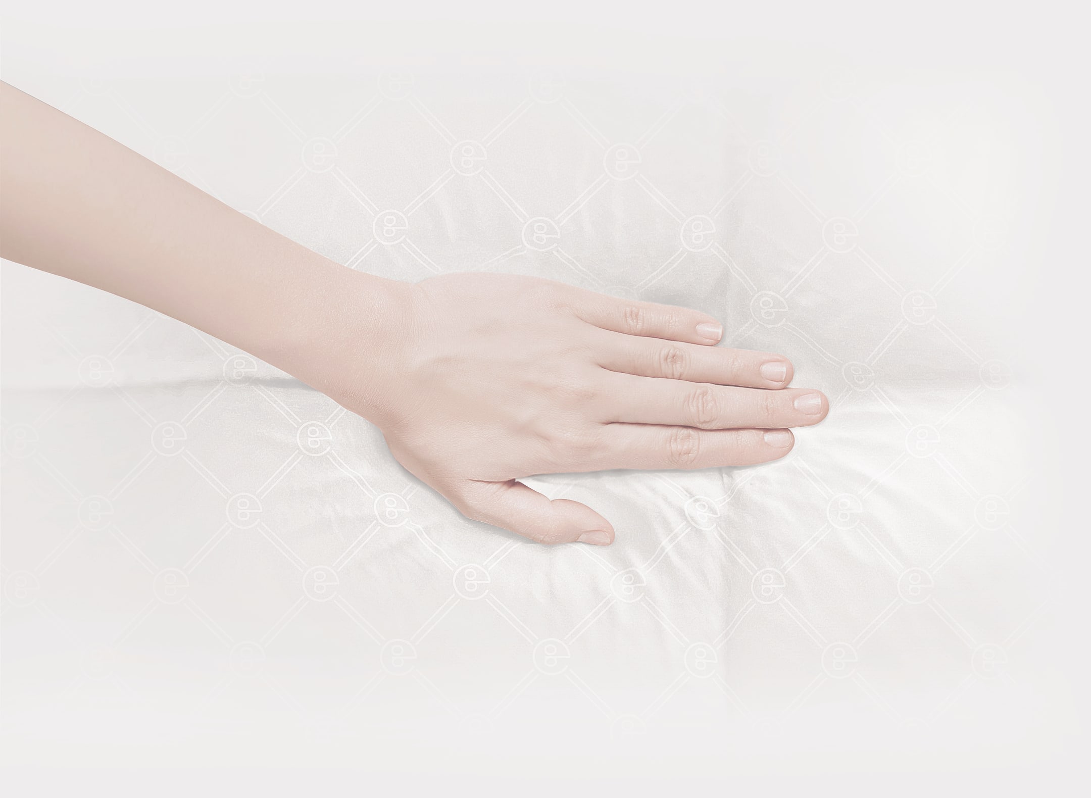 Hand pressing down on the Onebed Quilt which is giving away showing softness