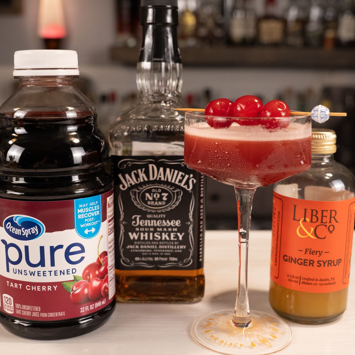 Cherry ginger cosmo with Jack Daniel's, tart cherry juice, and fiery ginger syrup in a coupe