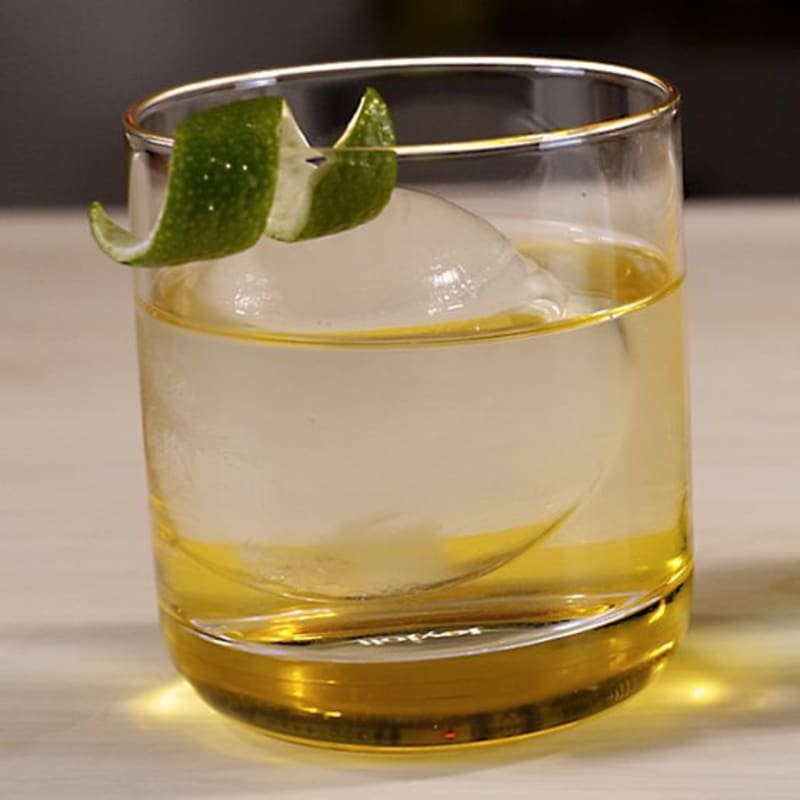 Clarified THC cocktail served crystal clear over a clear ice sphere