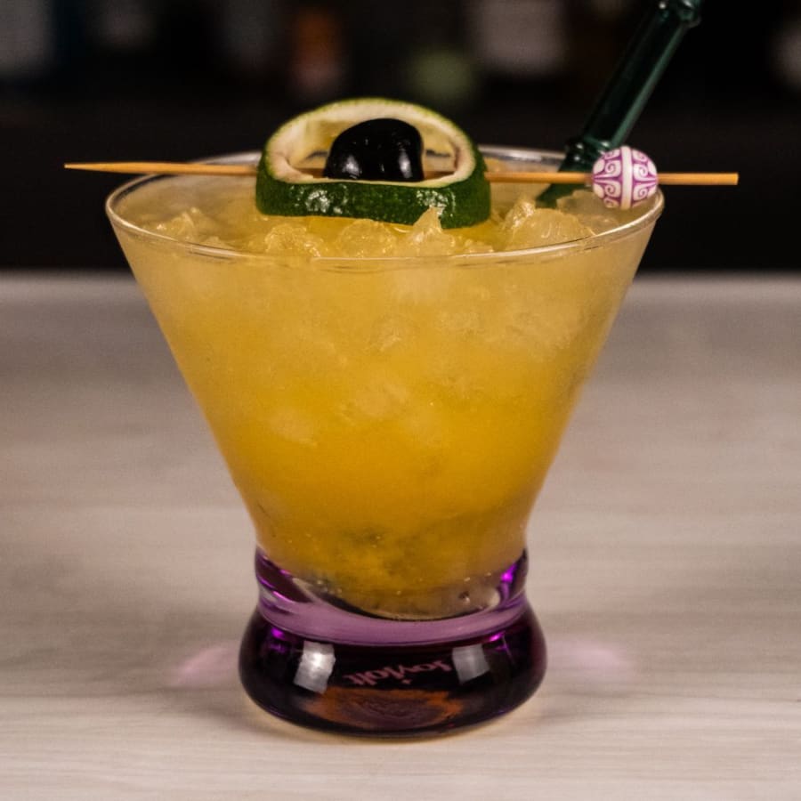 The Saturn, a gin tiki cocktail with passion fruit, in a coupe glass