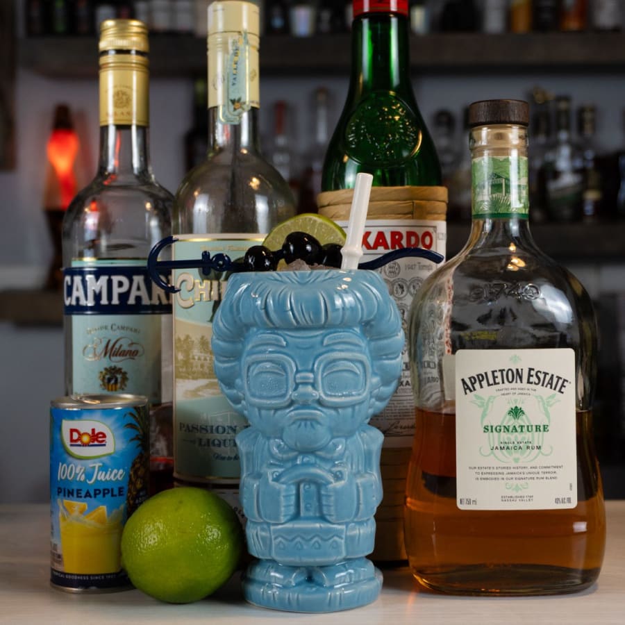 Lost Lake cocktail in a Golden Girls tiki mug with Jamaican rum, Campari, and passion fruit