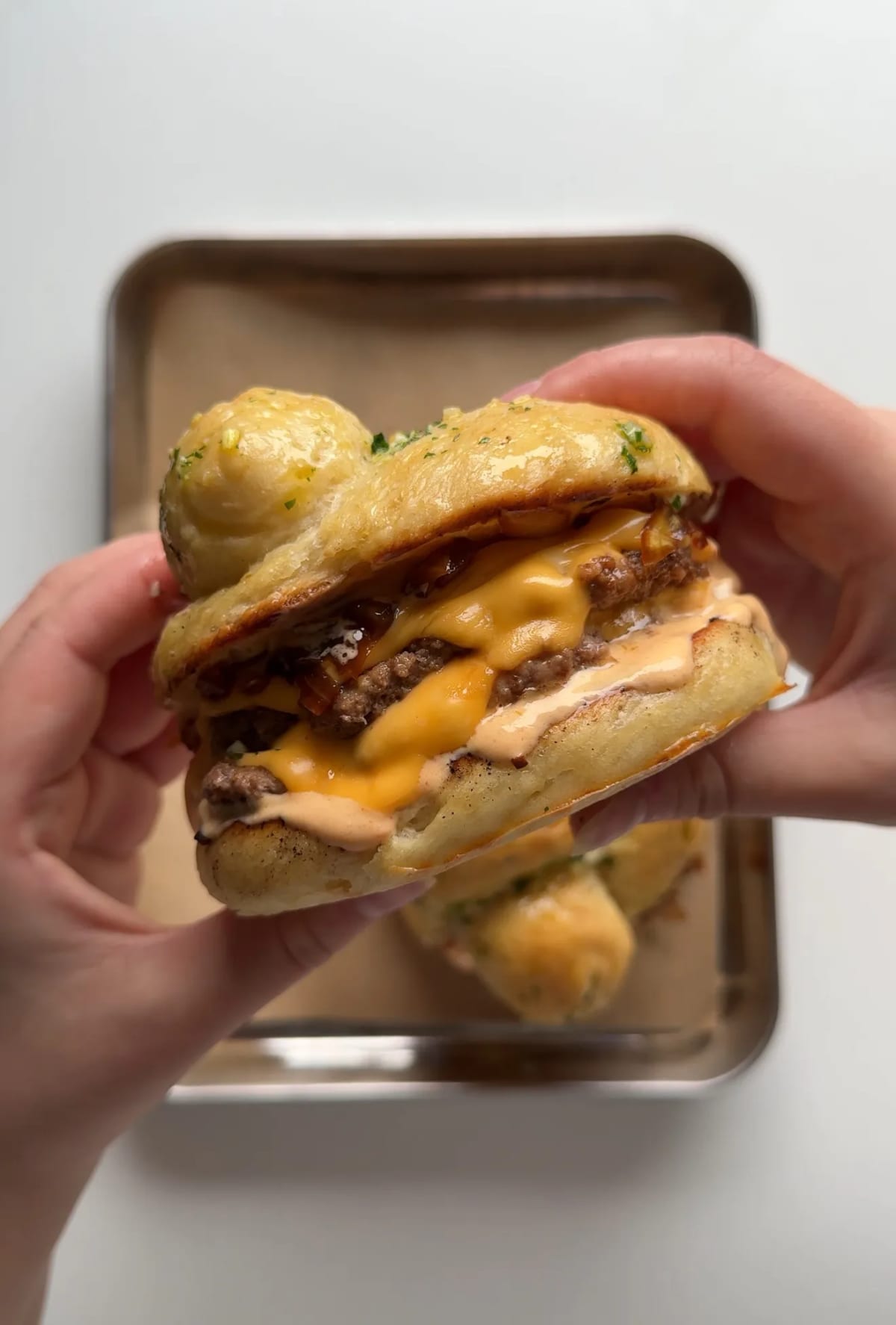 Garlic Knot Double Smash Burger with Caramelized Onion and Chipotle Sauce