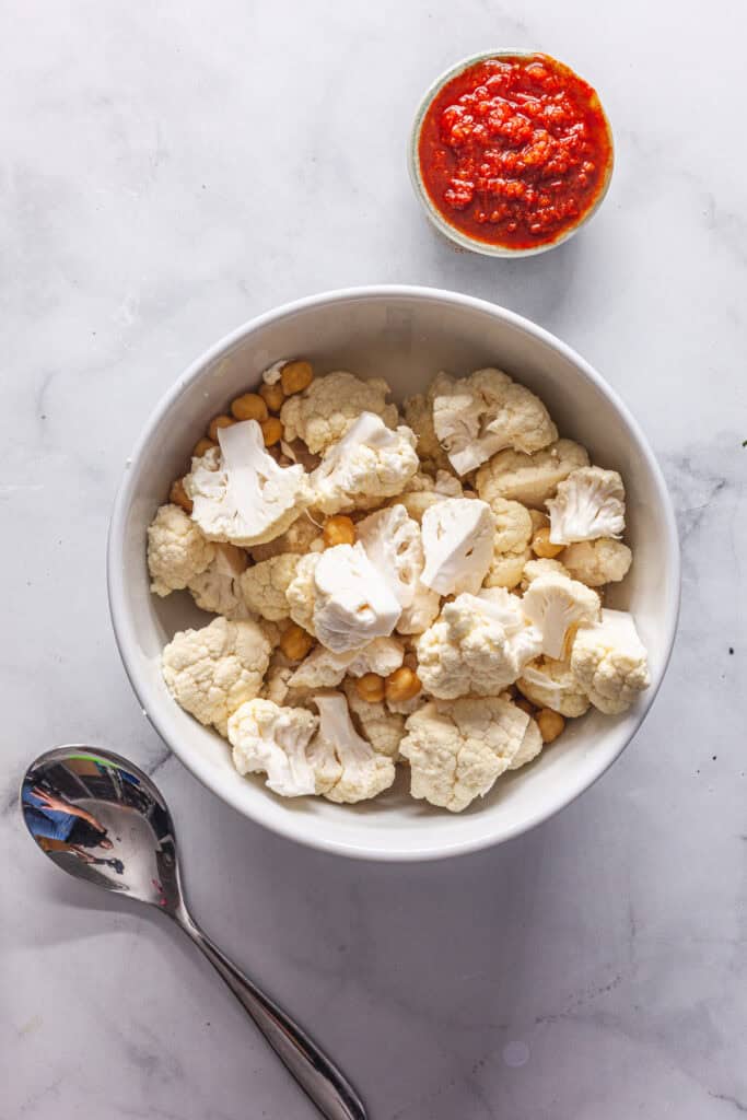 Harissa Roasted Cauliflower and Chickpeas with Tahini Sauce 