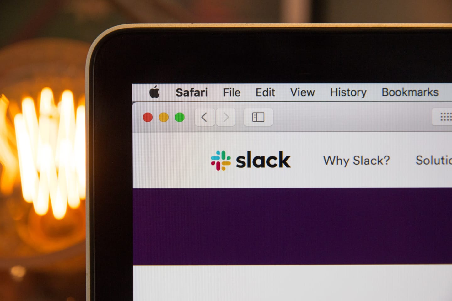 The top left corner of the Slack website in Safari, showing the Slack logo and a menu item with the text, 'Why Slack?'.