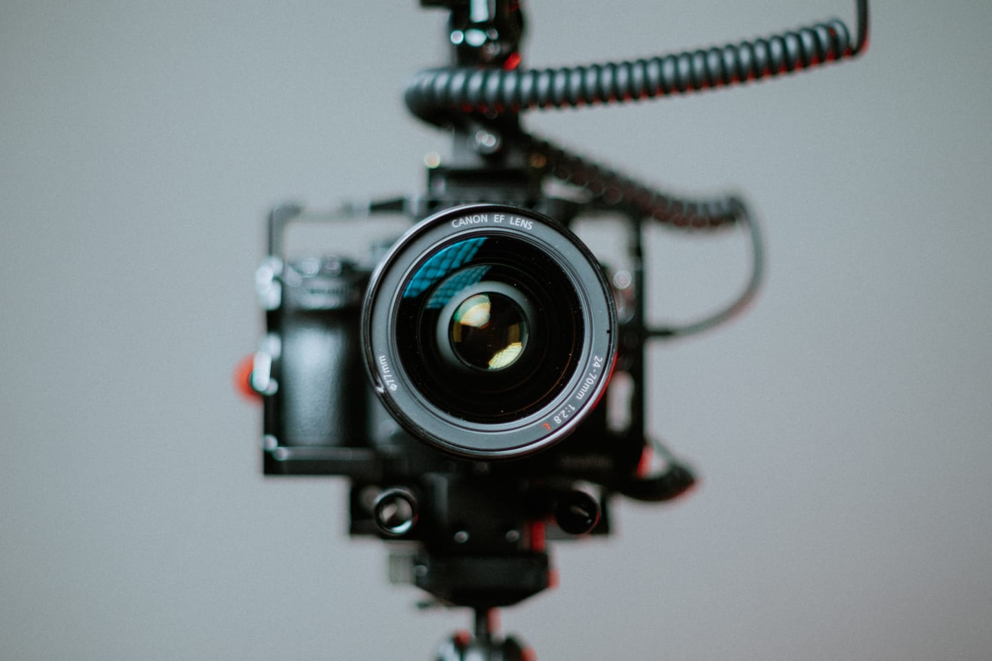 A video camera with a long telephoto lens pointing straight at you from one foot away.