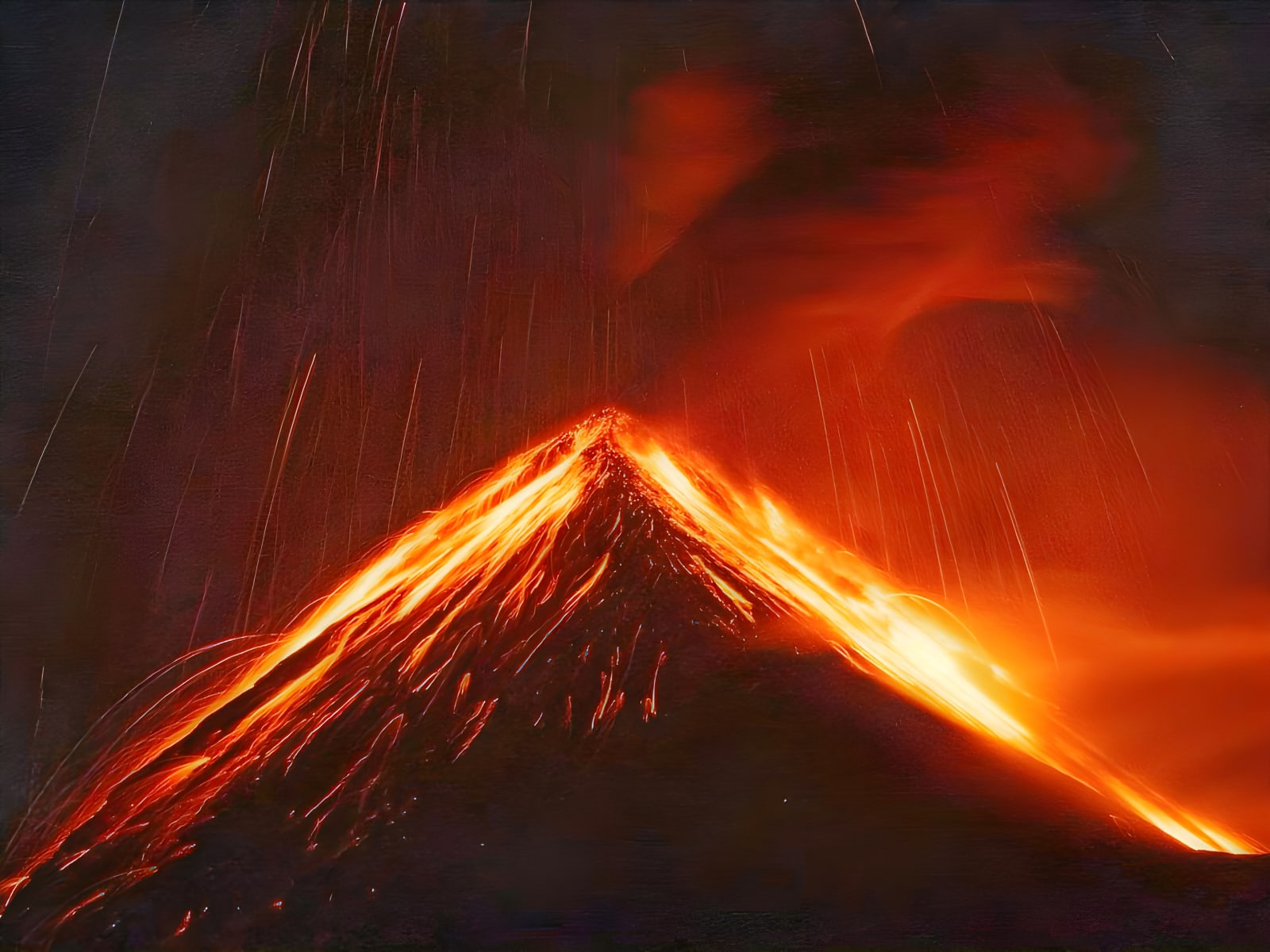 Fuego Volcano spewing lava at night, seen from Acatenango