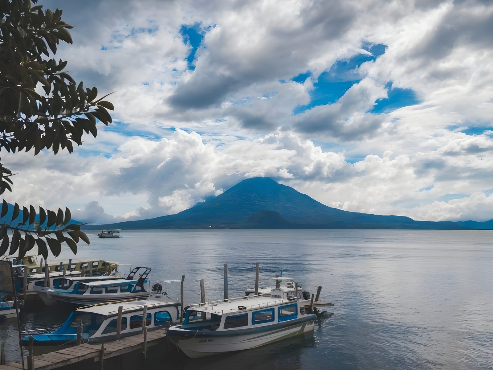 Boats at a Lake Atitlán dock facing the volcano