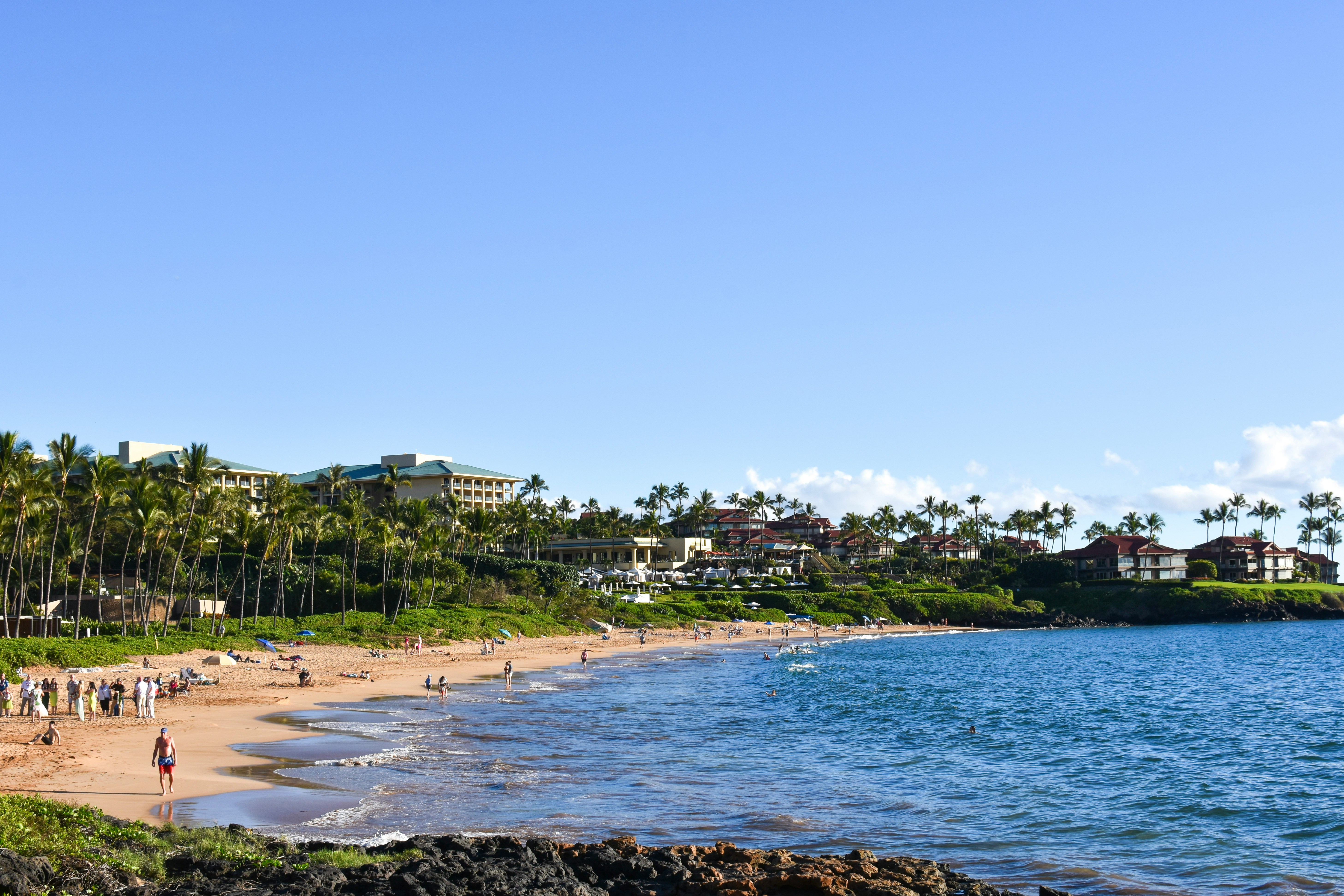 Beachgoers enjoy the South Maui coastline — Makena's wide sandy beaches and clear water draw visitors year-round
