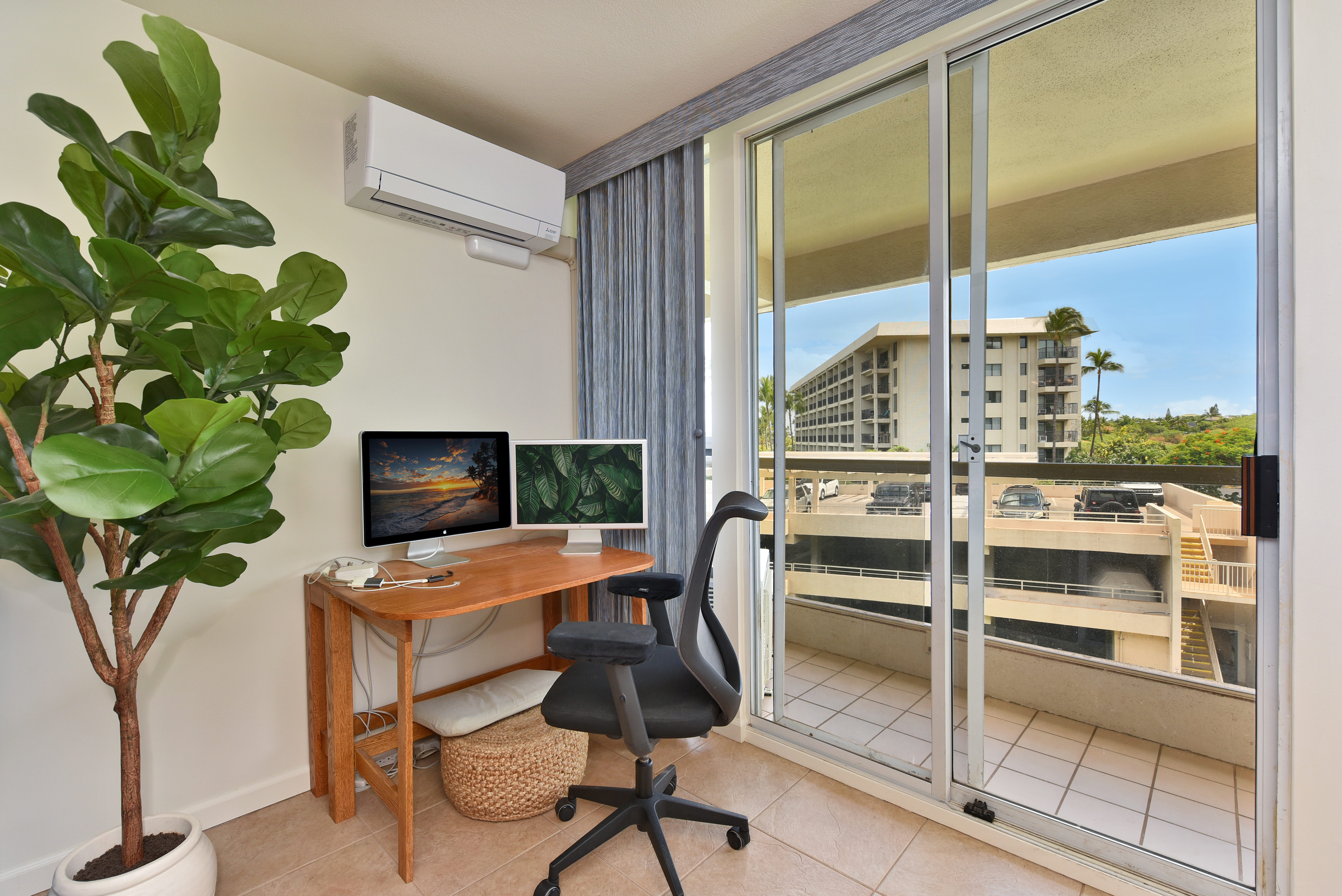 The dedicated work nook at P410 — desk, monitor, and lanai light