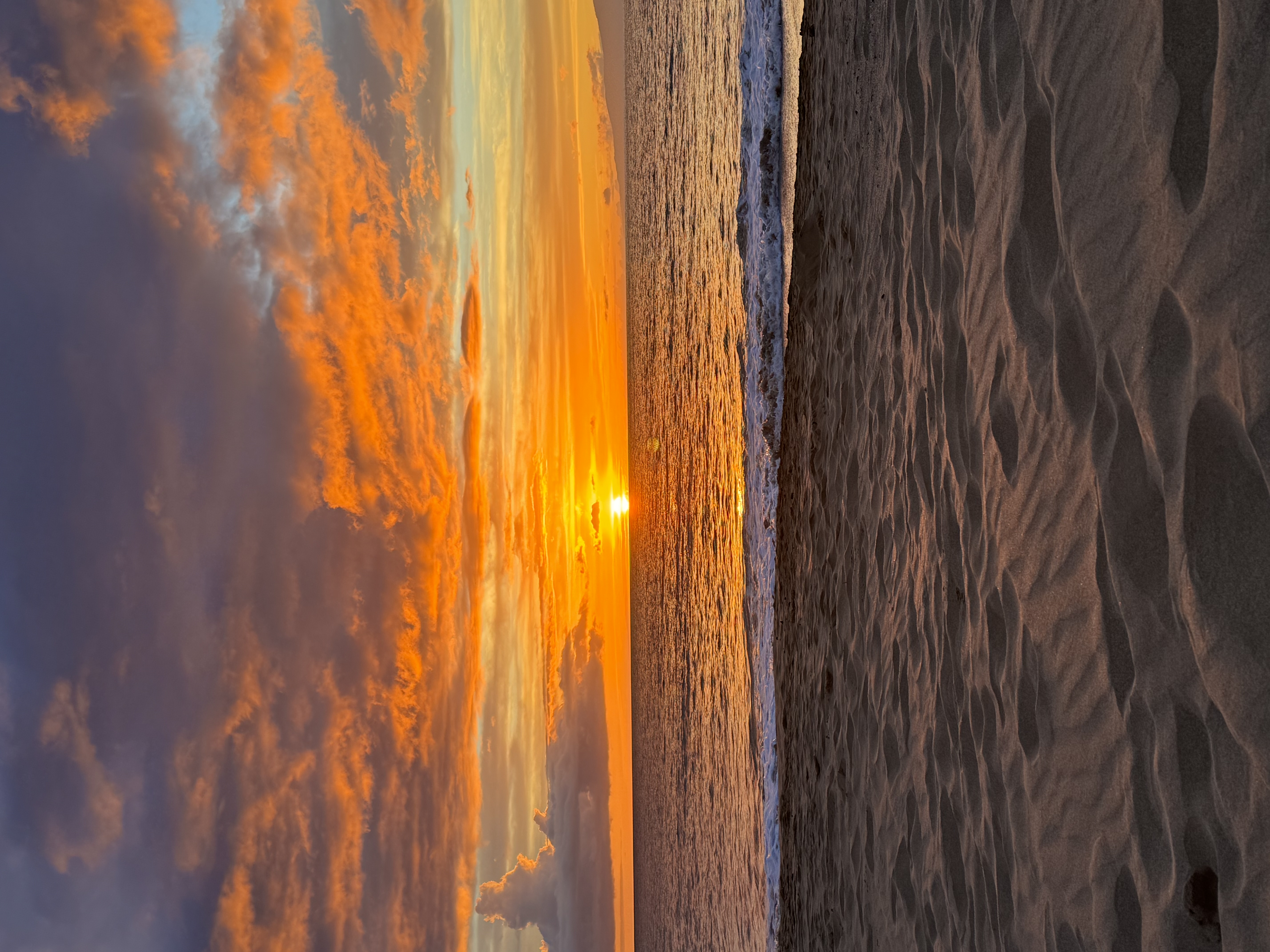 Pure fiery orange Kama'ole beach sunset — sun just below the horizon, March 2024
