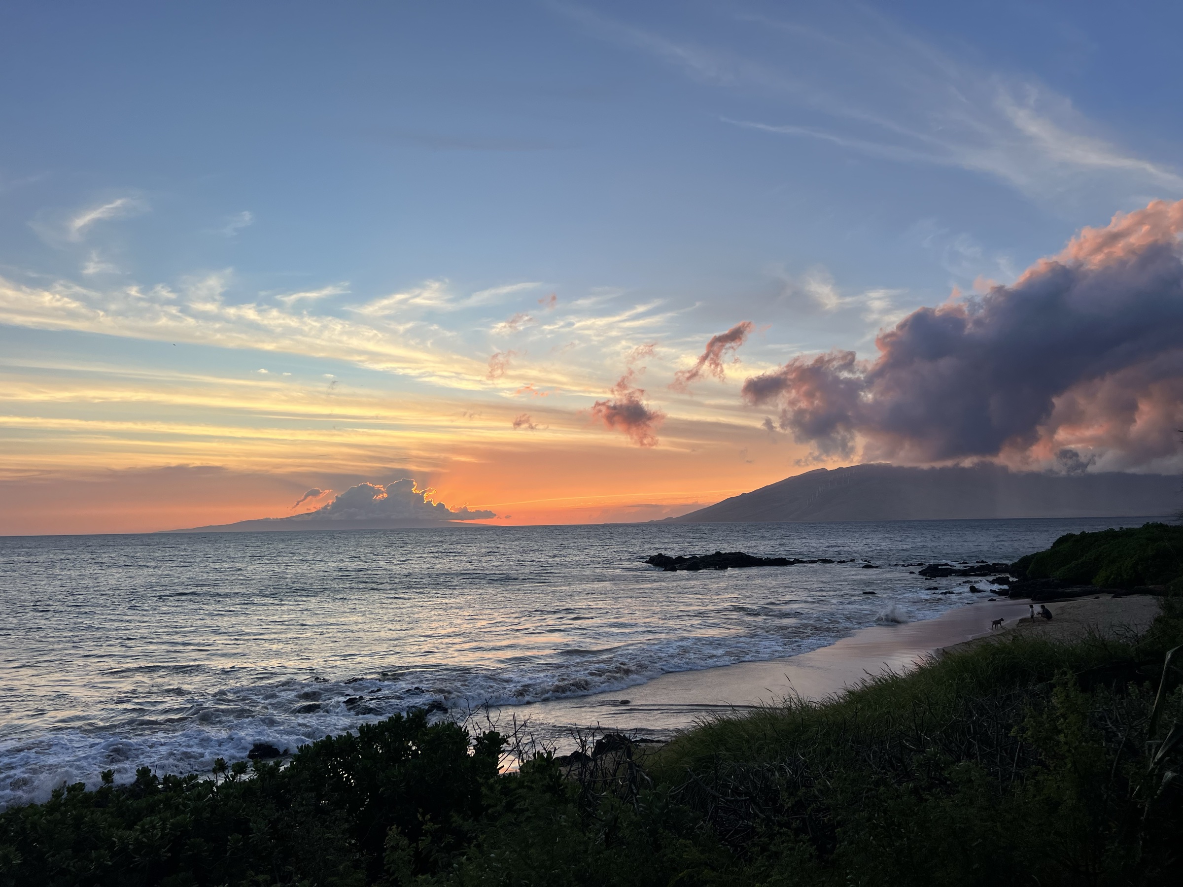 Secluded cove beach at sunset, West Maui mountains behind