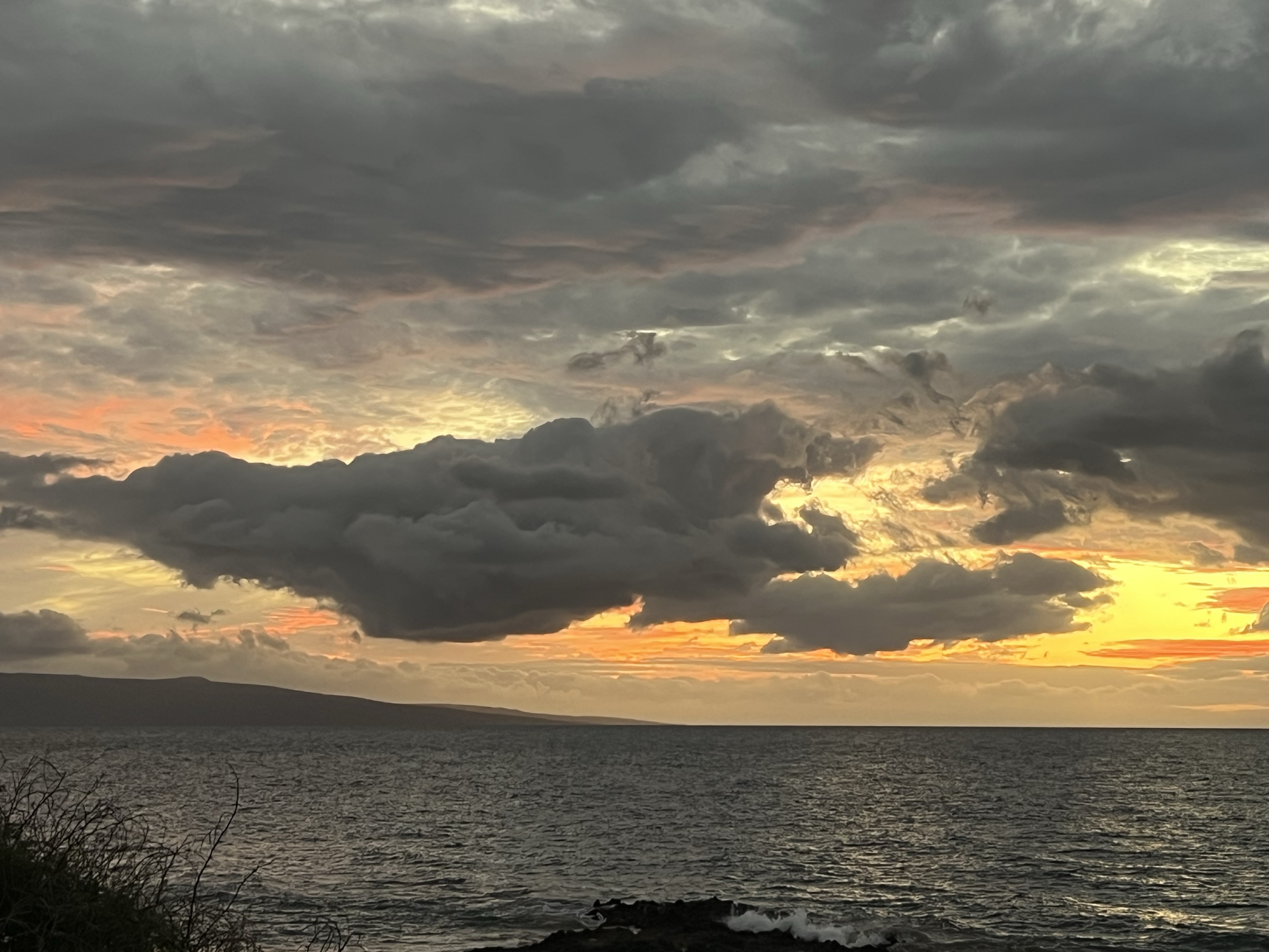 Dramatic stormy golden cloudscape over West Maui mountains