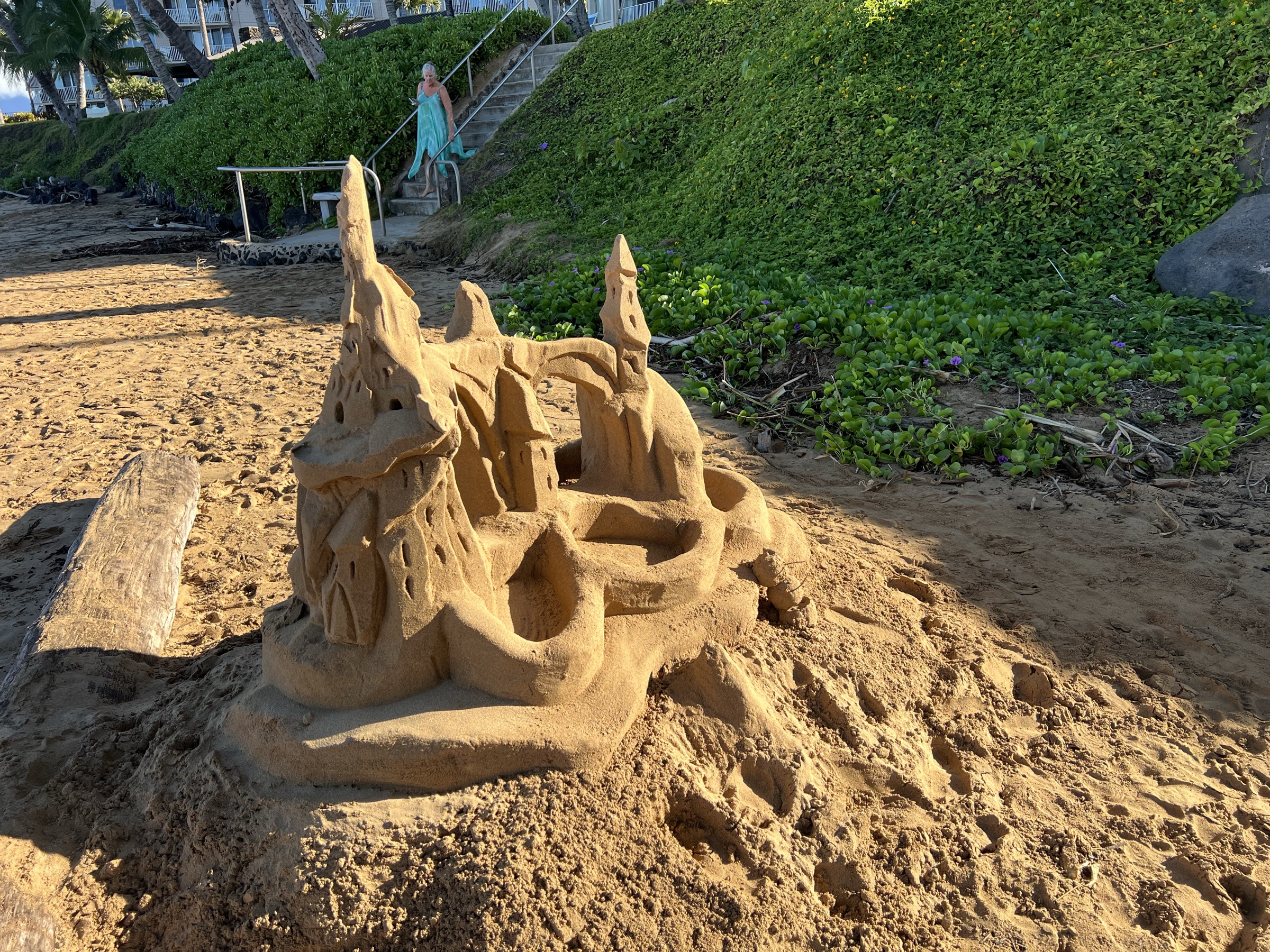 Overpass sand sculpture — full view with beach stairs for scale