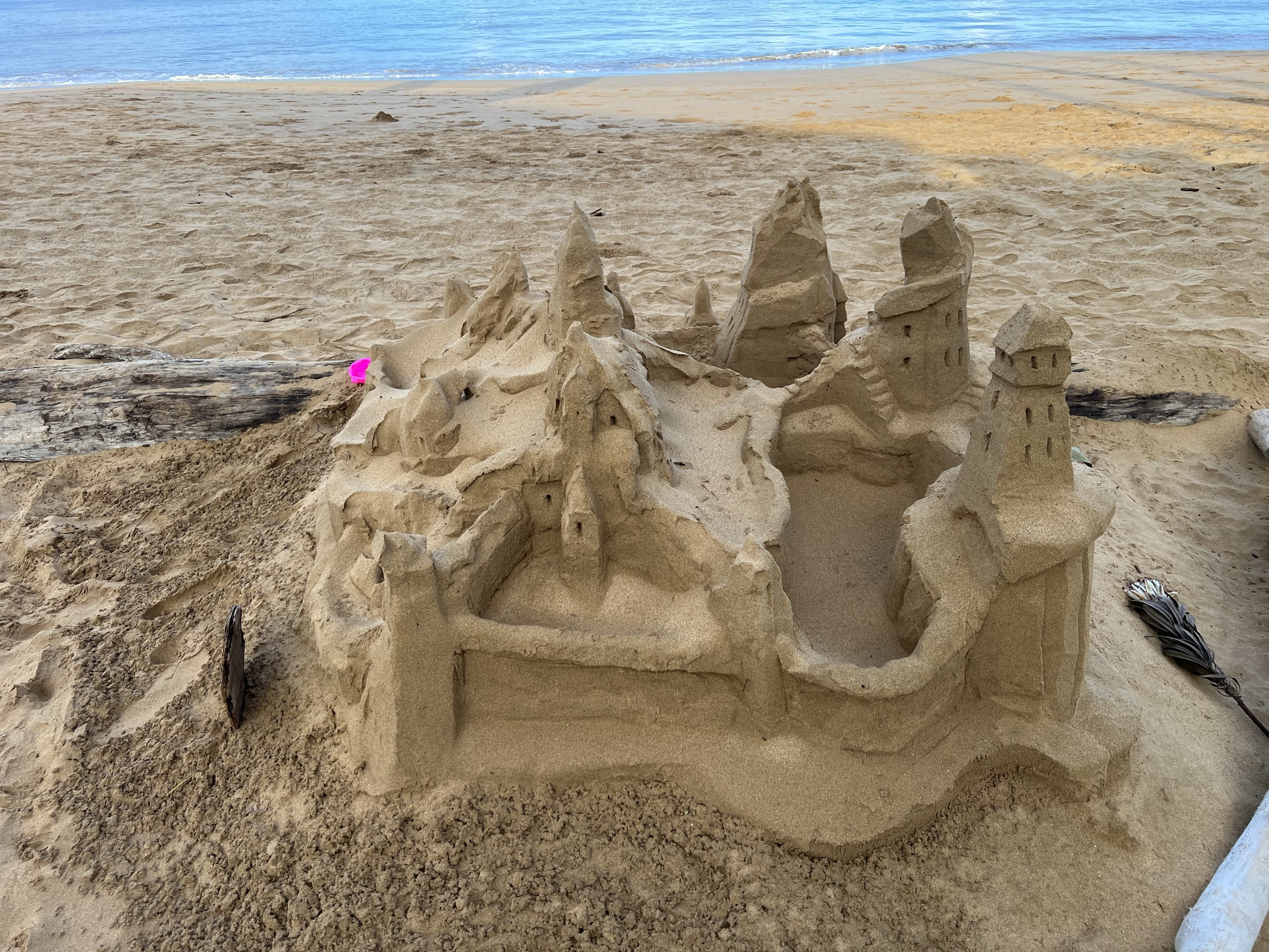 Queen's Castle sand sculpture on Kama'ole beach with the Pacific behind it