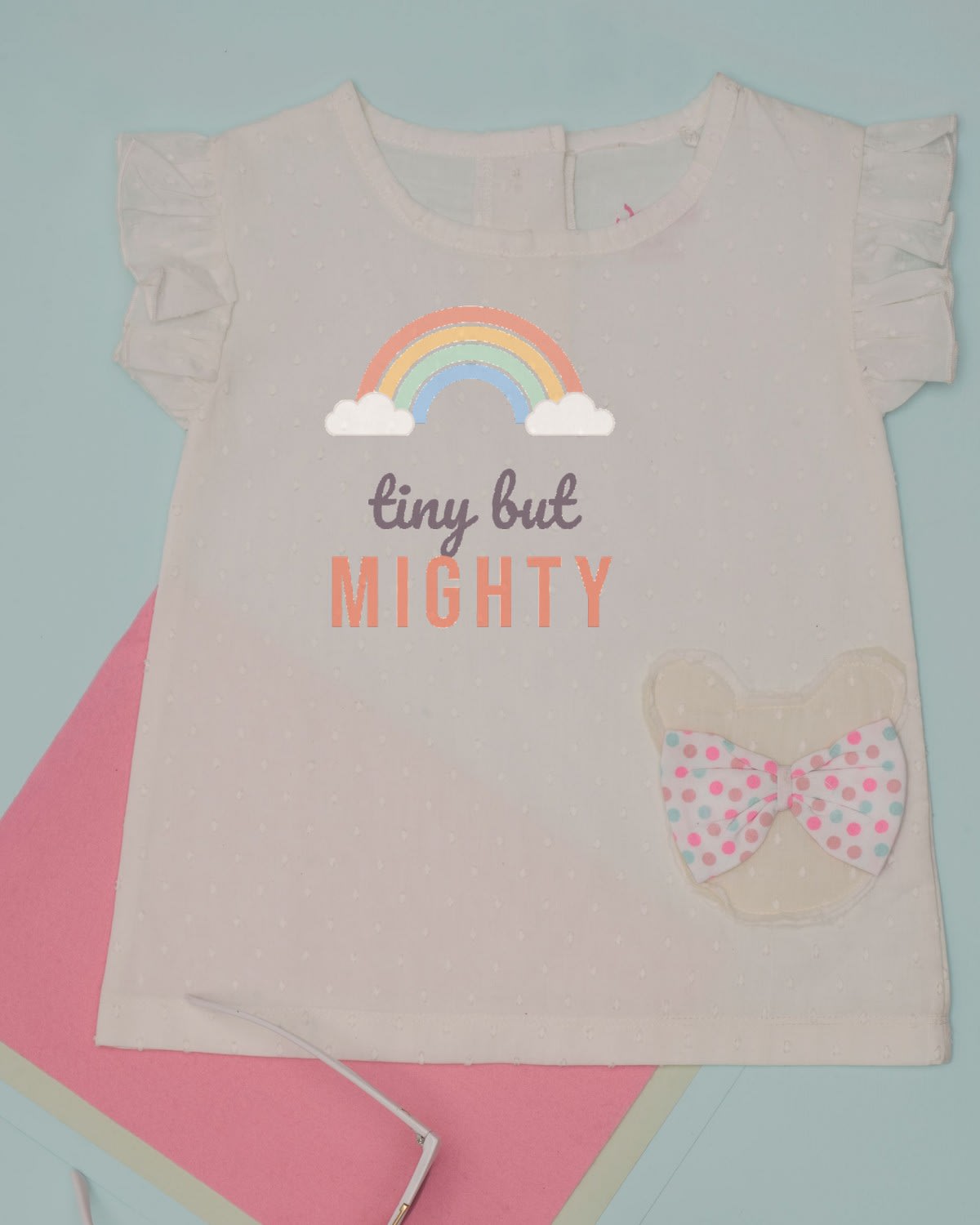 Tiny But Mighty SVG printed on a baby bodysuit