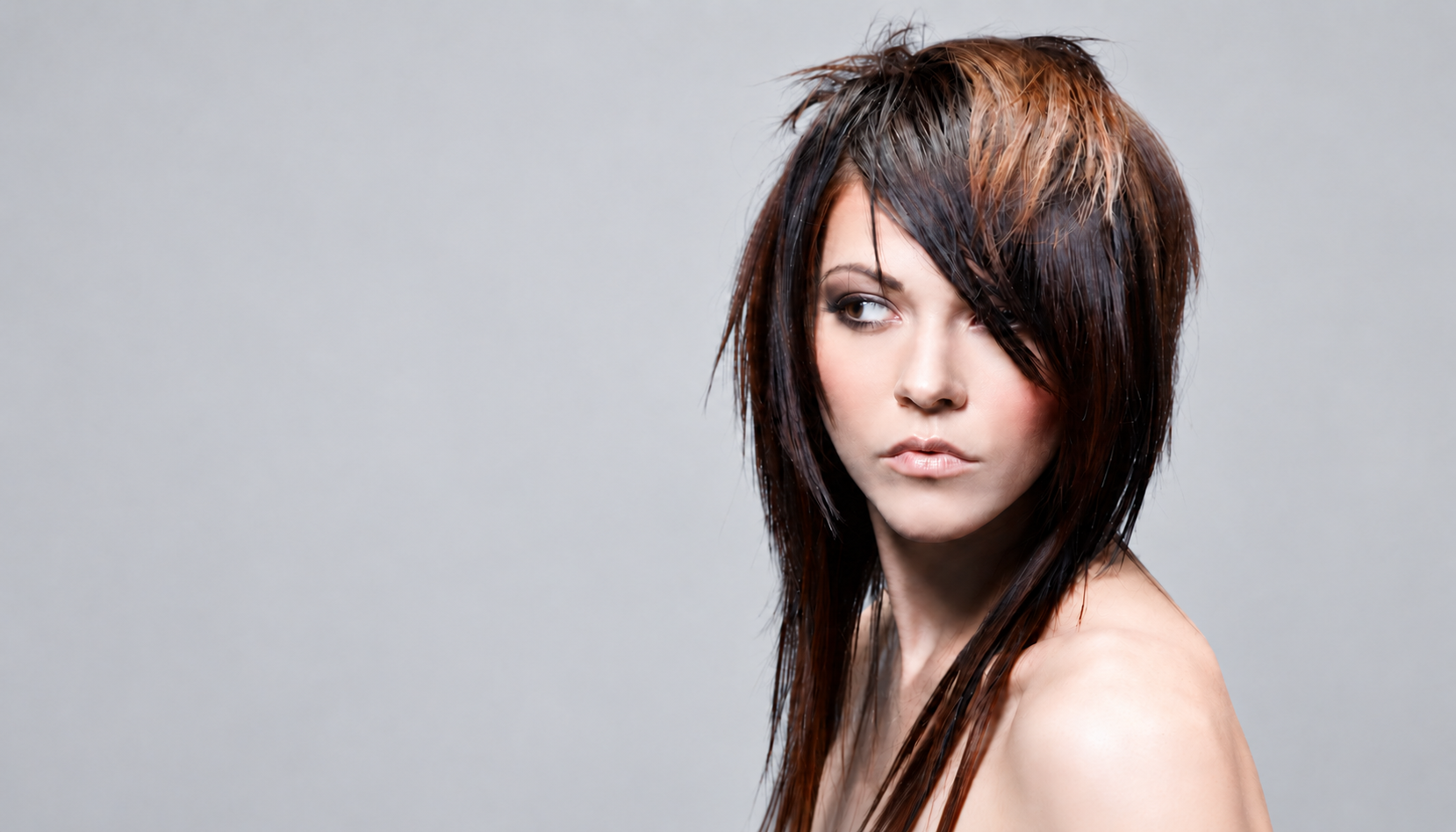 Professional men's haircut featuring precision barbering, tapered sides and styled textured hair.