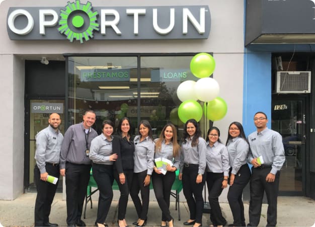 Photo of Oportun staff lined up in front of Oportun loan place