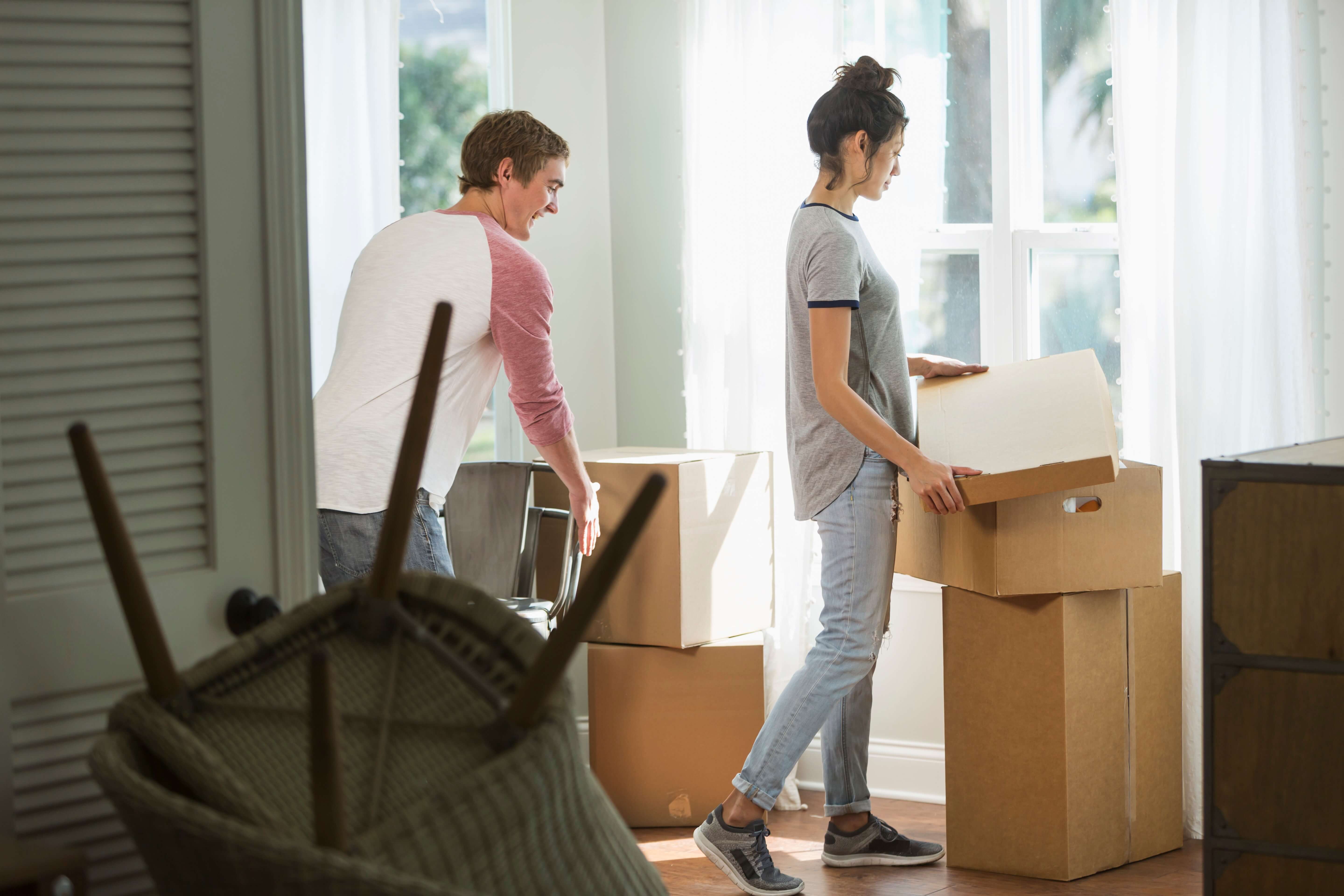 Image of couple unboxing in their new apartment, made possible through their Oportun loan