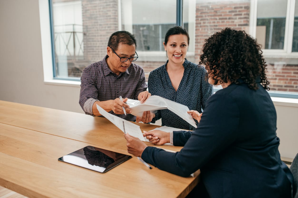 Three people discussing financial possibilities