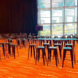 A spacious room filled with numerous tables and chairs, available for Black Tolix Stool hire.